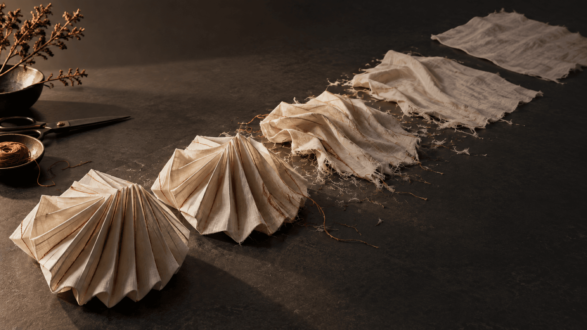 Distinctive pleated textile forms progressively flattening and fragmenting over time.